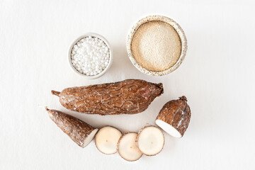 Close-up of a cassava root on a white background with tapioca pearls
