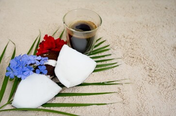 Top view coffee with coconut on the beach.                             
