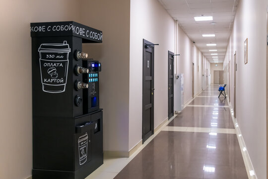 Russia, Moscow - June 17, 2023: Black automated self-service cafe with Unicum Nero bean-to-cup table top vending coffee machine stands in hall of public building. Illustrative editorial