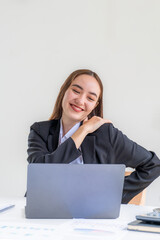 Young businesswoman feeling pain and stretch herself after working hard on computer laptop for a long time, Office syndrome concept