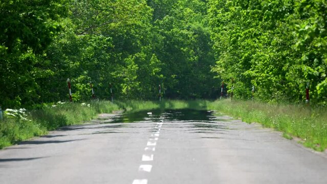 
Hokkaido, Japan - June 8, 2023: Road mirage or water mirage or inferior mirage on a road in Betsukai, Hokkaido, Japan
