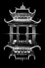 a temple on the water with symmetrical reflection