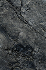 Dark rock texture background.Dark aged and cracked of black stone.