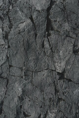 Dark rock texture background.Dark aged and cracked of black stone.