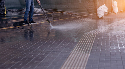  Outdoor floor cleaning with high pressure water jet.