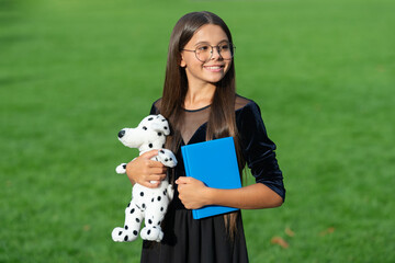 childhood education of smiling teen girl with toy and book. childhood education of teen girl...