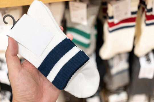 socks with blank tag. man choosing socks at the shop