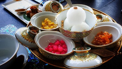 Obraz na płótnie Canvas Coconut ice cream served with Thai desserts at Thai restaurant in Bangkok, Thailand, Asia. 