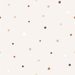 Seamless pattern with brown hand drawn dots on a beige background.