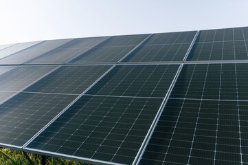 Obraz premium At sunny daytime. Close-up view of solar cell farm power plant eco technology