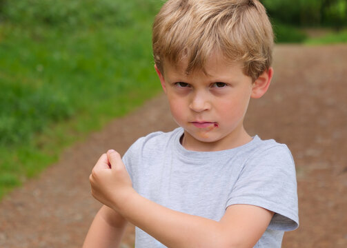 portrait of little boy shows his fists