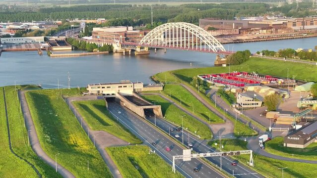 Aerial View Of A15 Motorway Ridderkerk Beside Crezeepolder And Brug over de Noord In Background During Golden Hour. Dolly Back
