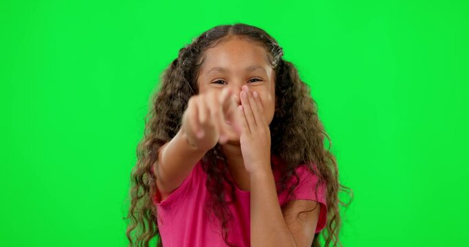 Girl child, green screen and laugh with point at you for comic joke, bullying or funny in studio mockup. Young female kid, secret and crazy laughing with pointing, choice or comedy with happy smile