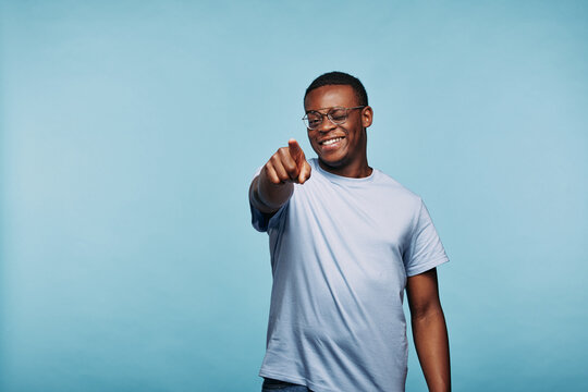Smiling African man winking and pointing