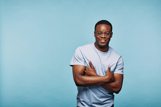 Smiling African man standing with arms crossed
