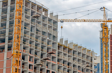 Fototapeta na wymiar Fragment of the facade of a residential building under construction on a summer day