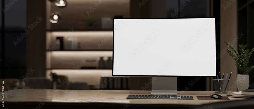 Canvas Prints a modern pc computer mockup is on a table in a modern home office at night. close-up image