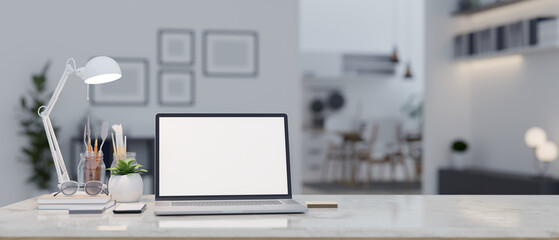 A laptop mockup on a table in a modern contemporary living room. close-up workspace.