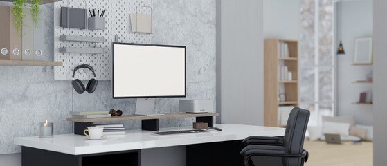 A modern loft office workspace with computer mockup and office supplies on a table