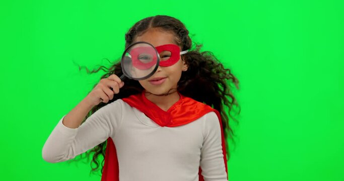 Search, green screen and girl child in studio with a superhero costume for halloween or a mission. Magnifying glass, playful and young kid model on an investigation isolated by chroma key background.
