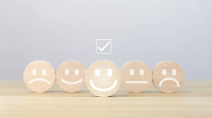 wooden block showing a smiley icon. customer review concepts, satisfaction surveys, positive feedback