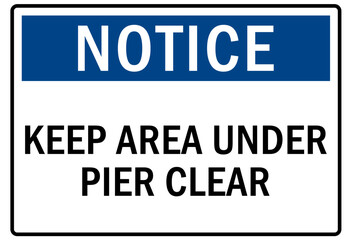 Beach safety sign and labels keep area under pier clear