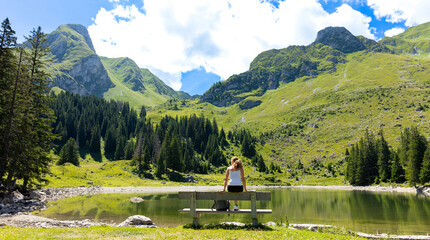Switzerland,  Swiss Alps aand lake- woman tourist enjoying beautiful green landscape
