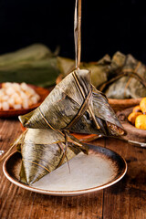 zongzi, rice dumplings,Made with glutinous rice and meat or egg yolk(Dates and Red Beans), wrapped in zong leaves, a common food for the Dragon Boat Festival in Asian countries.