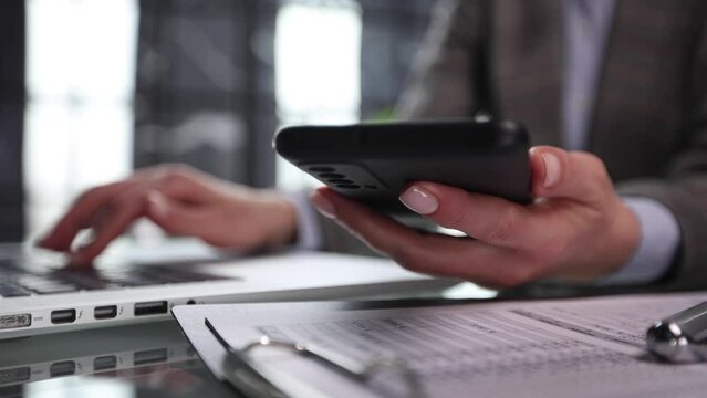 Side view shot of a man's hands using smart phone in interior