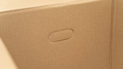 open cardboard boxes close-up, cutout for handle in cardboard box