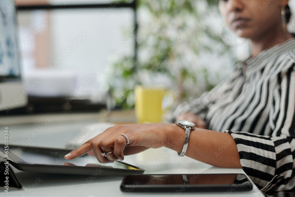 Aufkleber close-up of young female designer pointing at tablet screen while preparing presentation or scrollin