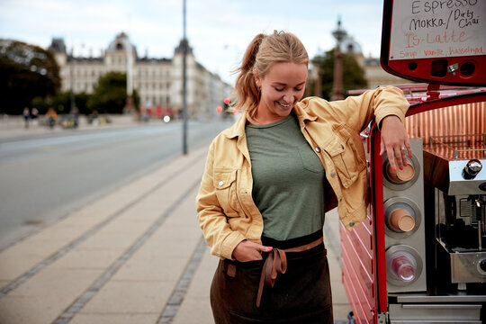 Smiling Barista Leaning Against Her Coffee Truck