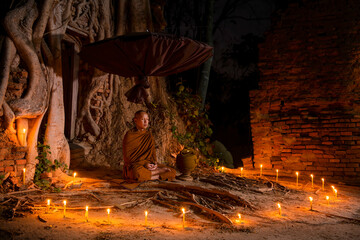 The monks sit in meditation to calm the body and mind which makes life happy.