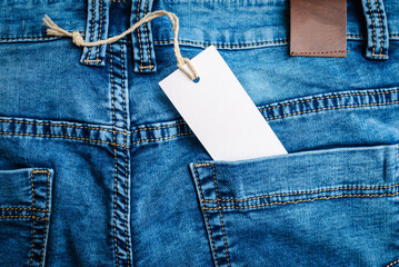 Blank label tag mockup on blue jeans.Blue Denim Jeans,belt,jeans pants with leather...