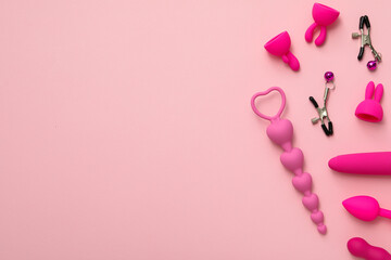 Collection of pink sex toys on a pink background