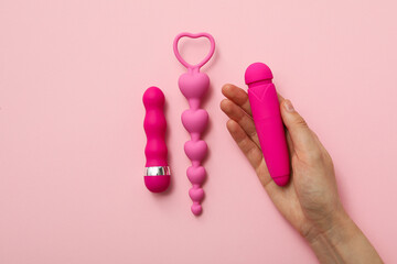 Collection of pink sex toys on a pink background