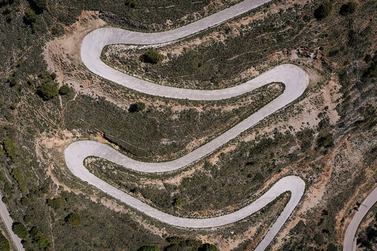 Drone point of view photograph with a winding mountain road in greek island Kefalonia
