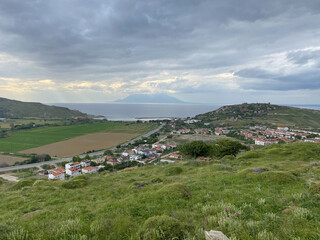 Fototapeta na wymiar Samothrace Island and Kalekoy view from Eski Bademli-Gliki village in Gokceada on a rainy day. Canakkale, Turkey. Imbros island panoramic seascape