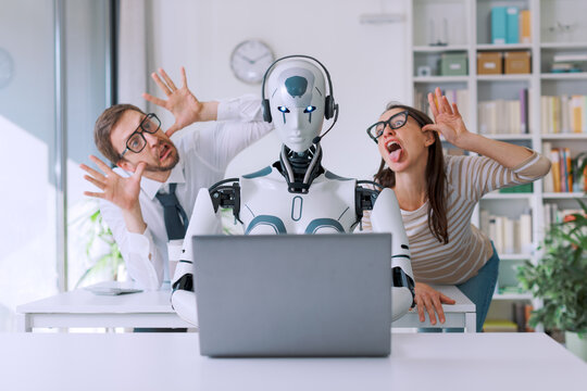 Office workers mocking their robot colleague