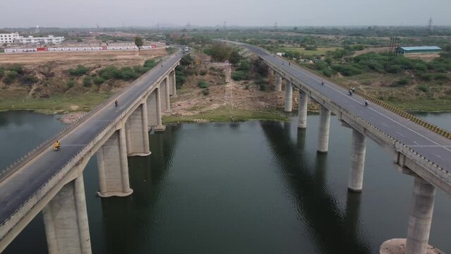Aerial view of the highway bridge built over the river basin in the mainland Indian rural terrain