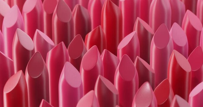 Many rotating lipstick swatches lined up in a pattern. Seamlessly looped video.