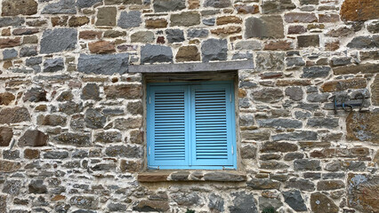 Traditional Greece, Mediterranean, Aegean type stone house window with blue blinds