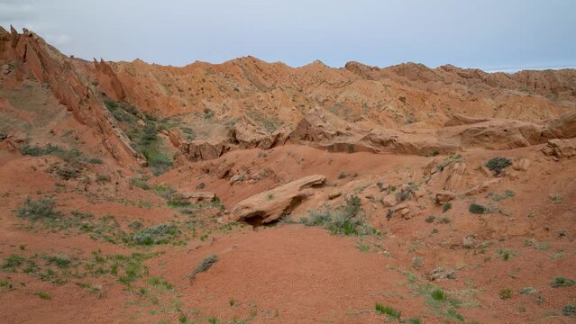 Scenery from Fairytale Canyon, unique rock formation located in Kyrgyzstan. Canyon is known for its unusual and colorful rock formations, which have been shaped over time by wind and water erosion.