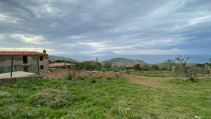 Fototapeta na wymiar Rural view of Gokceada Old Bademli village and Samothrace island view. Canakkale, Turkey