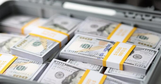 Closeup of briefcase full of stacks of dollar bills. Business success or crime and bribe concept