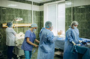 An obstetrician-gynecologist is preparing for childbirth In hospital
