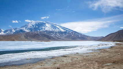 The bank of Karakul Lake under Muztagh Ata Peak