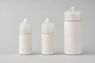 Refill liquid for electronic cigarettes on gray background