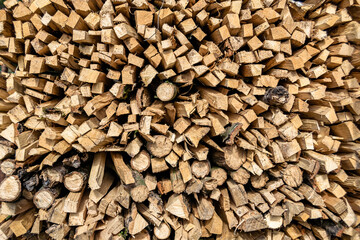 Photography on theme big wall of stacked oak tree logs in cracks