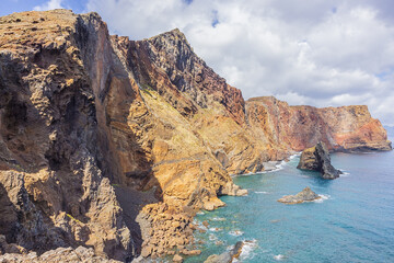 Brightly colored steep cliffs rising up from the ocean at the Ponta de Sao Lourenço, the most...
